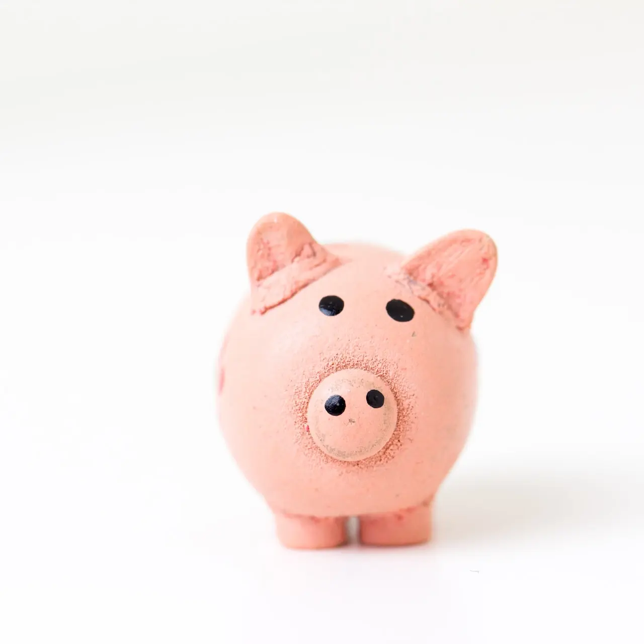 pink pig figurine on white surface